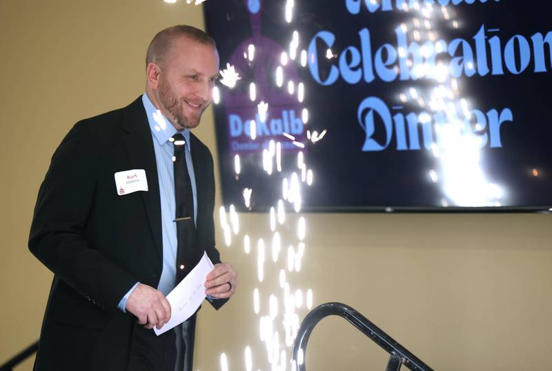 Kurt Mattson, from DeKalb Mechanical, walks past the sparklers to accept the Business of the Year Award on behalf of DeKalb Mechanical Thursday, Feb. 5, 2026, during the DeKalb Chamber of Commerce Annual Celebration Dinner at Faranda's Banquet & Conference Center.
