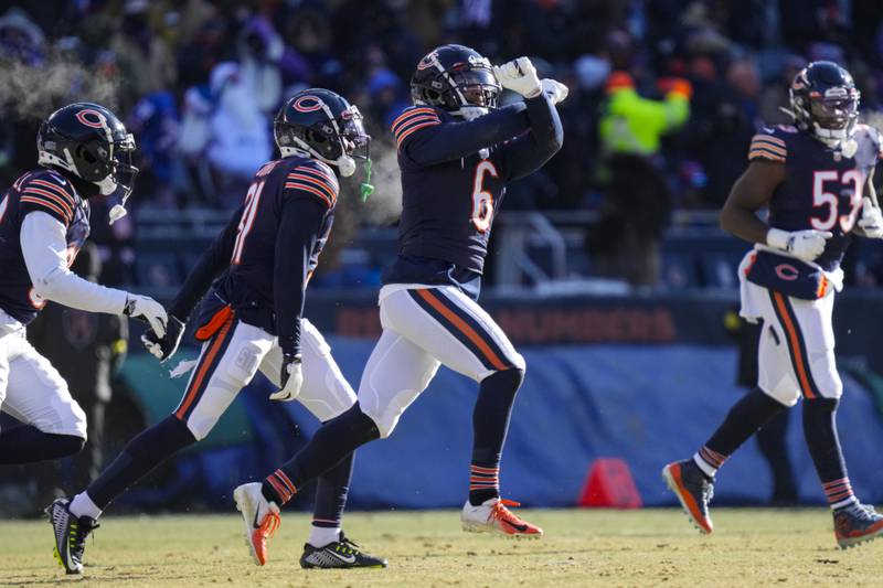 Chicago Bears cornerback Kyler Gordon (center) celebrates after an interception against the Buffalo Bills, Saturday, Dec. 24, 2022, in Chicago.