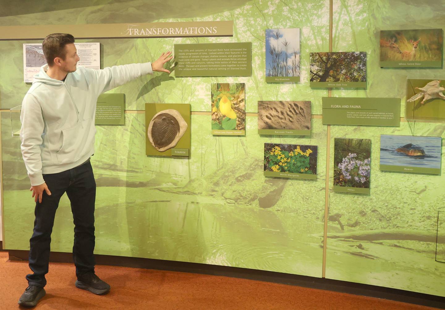 Matthew Klein, points to new signage and upgrades that were made inside the Starved Rock Visitors Center on Wednesday, Feb. 4, 2026 at Starved Rock State Park. Klein is the vice president of the Starved Rock Foundation.