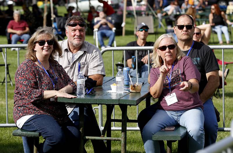 Cathey and Gary Mertz, from left to right, and Dawn Fedrigon and Bill Brill enjoy the music of Sharon Lewis and Texas Fire during McHenry Area Rotary Club's Blues, Brews & BBQ festival at Petersen Park in McHenry Saturday, August 20, 2022. The fundraising festival featured craft beer, blues music and barbecue and raises funds to go toward endeavors like the club’s Secret Santa program and Rotary Youth Leadership Awards, both of which foster the concept of looking out for one another.