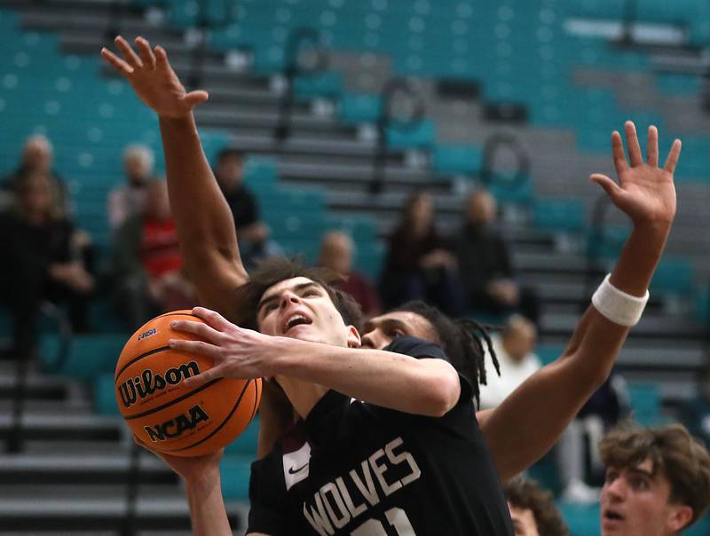 Prairie Ridge's Brendan Beu shoots the basketball in front of Grayslake North's Rees Jorden during the 2025 Hoops for Healing tournament basketball game on Wednesday, Nov. 26, 2025, at Woodstock North High School.