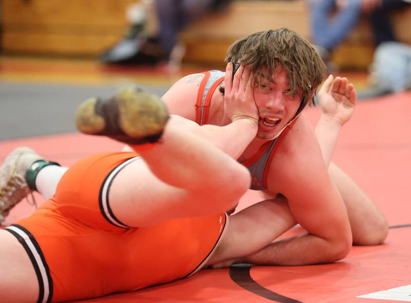 Minooka's Hunter Coons attempts to push away Yorkville's Hunter Janeczko, in grey, during the Southwest Prairie Conference wrestling meet at Yorkville High School on Saturday, Jan. 21, 2023.