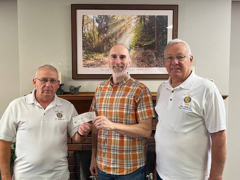 Stan Ballard, Mt. Morris American Legion Post 143 commander, right, and Mike Fay, Mt. Morris American Legion Post 143 treasurer, left, present, a check for $250 to Bruce McKanna, senior pastor of the Evangelical Free Church of Mt. Morris.  It is designated for the “All Hands On Deck” care package project for all 350 sailors aboard the USS Fitzgerald.