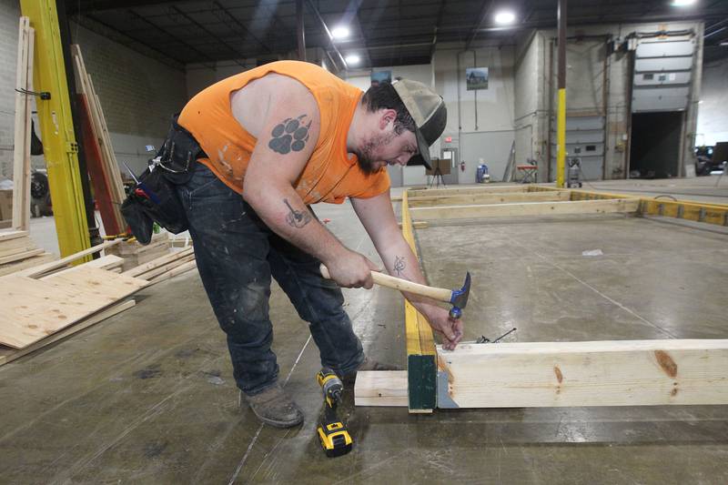 Jack Beucher, of Silver Lake, Wis., framer, works on framing the foundation for a Milla Long, the largest unit prefabricated tiny home with 456 sq. ft., in the factory at PrefabPads LLC in Waukegan on July 17th, 2023.
Image by Candace H. Johnson for Shaw Local News Network