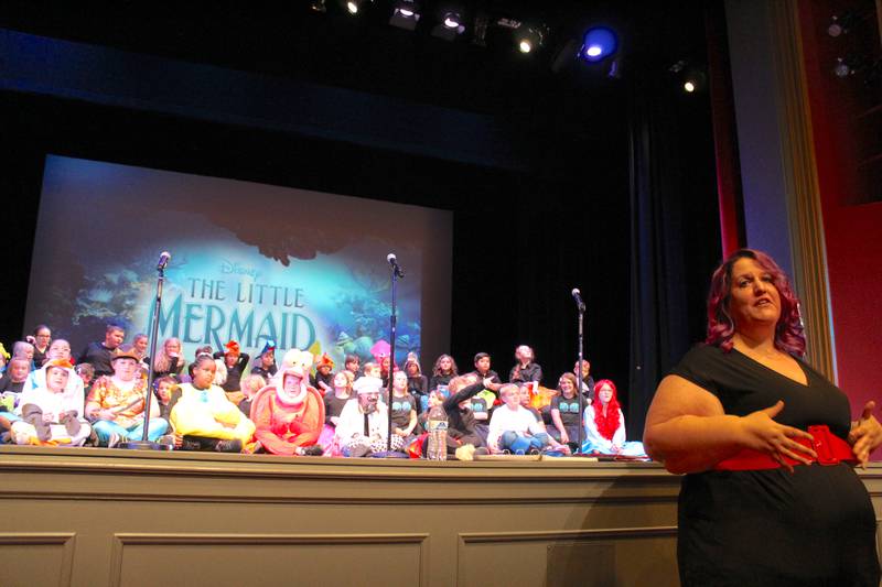 April Tamulen thanks the Streator High School Auditorium crowd with the cast of "The Little Mermaid Jr." sitting behind her at the conclusion of the performance Friday, May 5, 2023.