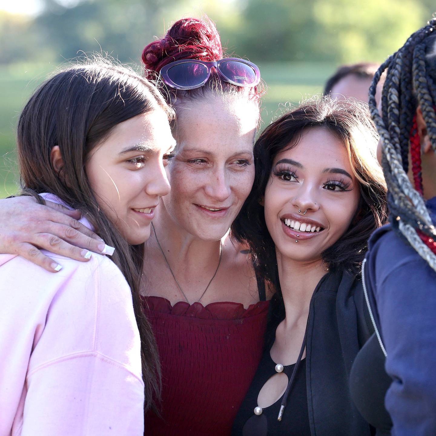 Ericka Sasso, (middle) mother of Gracie Sasso-Cleveland, gets a hug from some of Gracie’s friends Friday, Sept 15, 2023, at the Sycamore Community Sports Complex during a celebration of the life of Gracie on what would have been her sweet 16 birthday. Sasso-Cleveland, 15, was found dead May 7, 2023, in DeKalb. Timothy M. Doll, 29, of DeKalb, is charged with first-degree murder in her death.