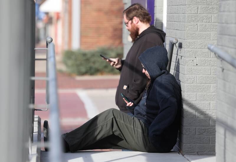 Customers wait to be let in Friday, Nov. 24, 2023, for the soft opening of Excelleaf in DeKalb. The business is DeKalb County’s first recreational marijuana dispensary.