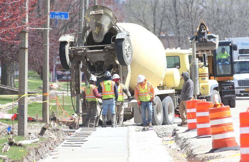 Crews pour a new sidewalk along U.S. 6 in front of the Westclox building on Monday, April 7, 2025 in Peru. The $6.4 million project is scheduled to be completed this summer, according to the release.
