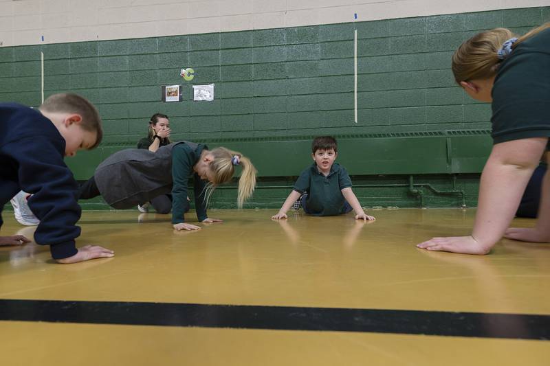A group works on their push-ups Thursday, Feb. 2, 2023 at St. Andrew Catholic School in Rock Falls.