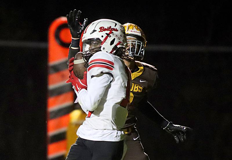 Bradley-Bourbonnais’ LyZale Edmon, front, reels in a touchdown reception ahead of Jacobs’ Owen Hoffman in first-round IHSA football playoff action on Friday, Nov. 1, 2024, at  Jacobs High School  in Algonquin.