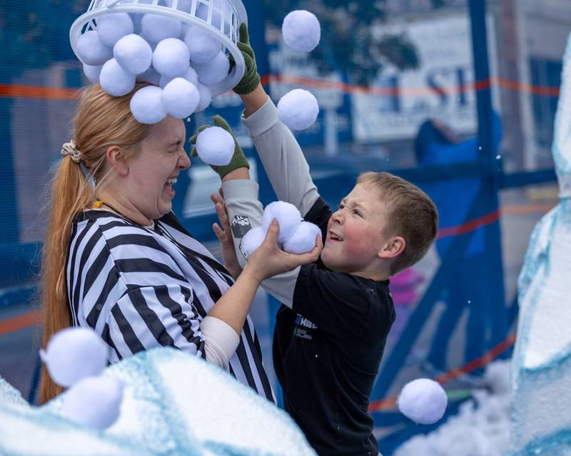 Kid dumps bucket of "snowballs" onto referee at the annual 'Ax Church Ultimate Snowball Fight' at Frosty on First on Saturday, November 8, 2025 on First Street in La Salle.