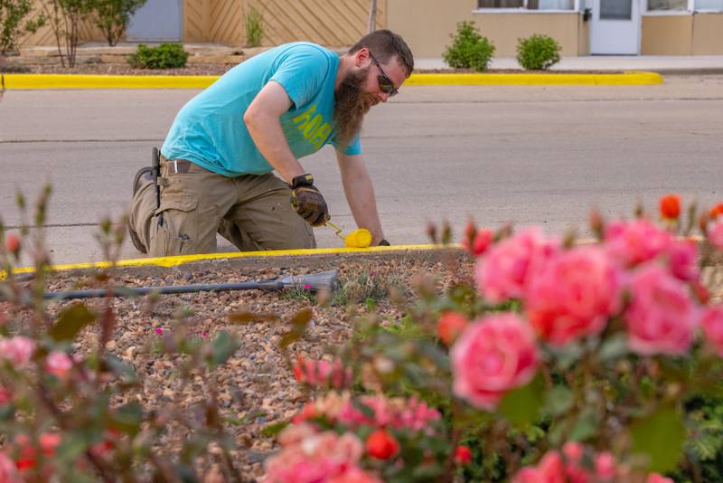 Luke Holdcraft paints curbs as part of a Hope Week project on June 2, 2025 in Spring Valley.