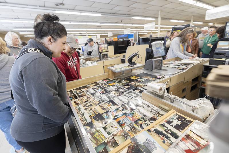 Friends, family and former employees of Oliver’s Corner Market visit and file through pictures Saturday, April 4, 2026, during a celebration of the Dixon grocery store. Owners Tim and Patty Oliver recently retired and sold the store after 39 years.