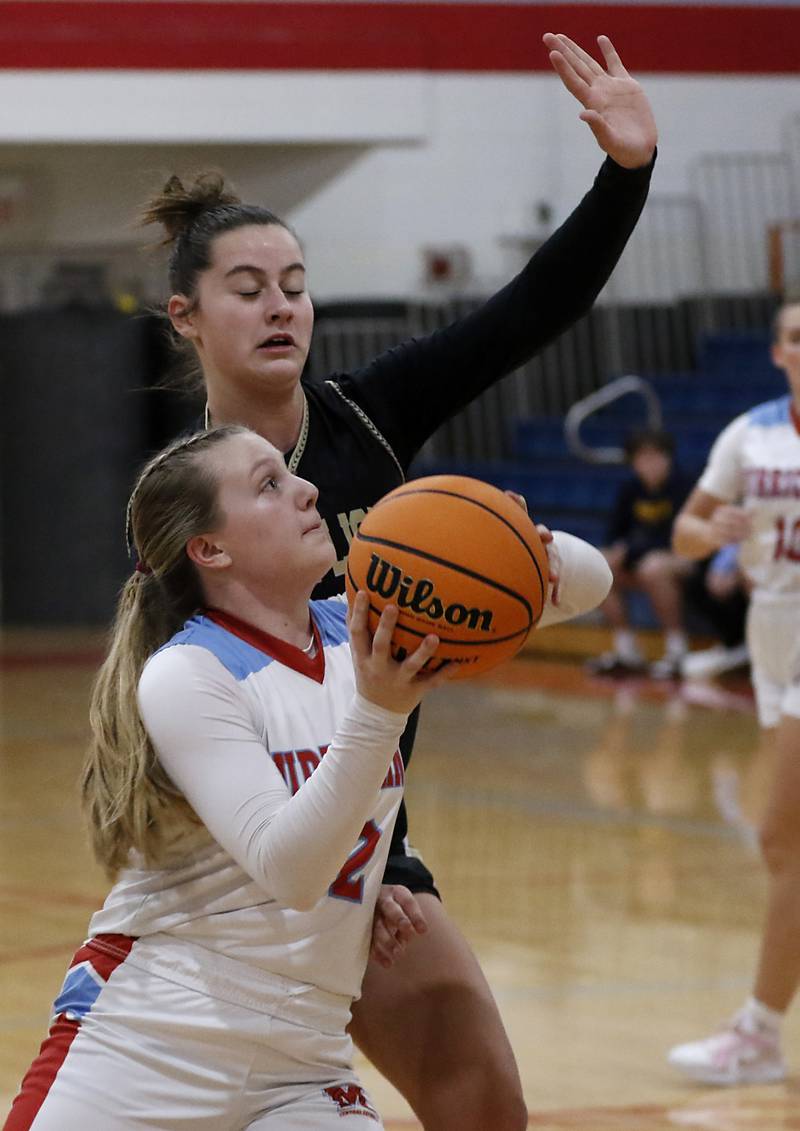 Marian Central's Abbey Miner drives to the basket agains Rockford Christian's Teagan Lawver during a nononference basketball game on Monday, Feb. 10, 2025, at Marian Central High School  in Woodstock.
