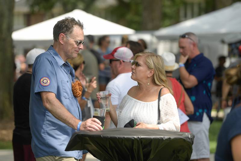 Tim and Lisa Dreyer of Geneva enjoy some craft beers while at the Wheaton Brew and Seltzer Fest in Memorial Park on Saturday, August 6, 2022.