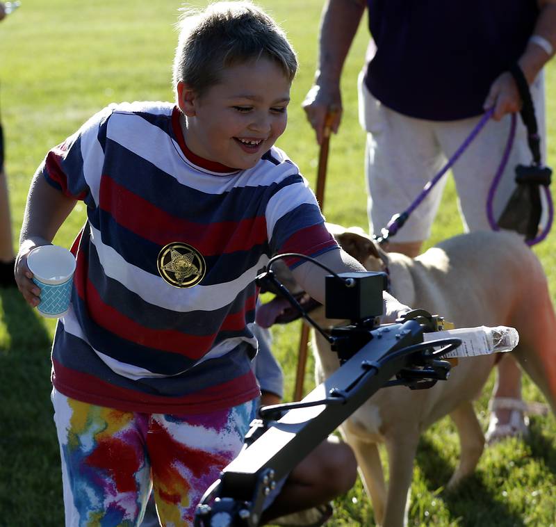 Kai Kray, 7, of McHenry, tries to retrieve his toy from the jaws of the McHenry County Sheriff Departments emergency robot during National Night Out! Tuesday, August 9, 2022, at Petersen Park in McHenry. The event was put on by the McHenry County Sheriff’s Office, City of McHenry Police Department and the McHenry County Conservation District and featured demonstrations, food and fun activities. National Night Out is held nationally in over 50,000 cities and is designed to help create relationships between neighbors and law enforcement community.