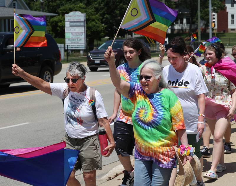 Lana Haines, (left) from Kingston, and Peg Rozhon, from Malta, march in the parade heading south on First Street Saturday, June 21, 2025, during the DeKalb Pride Fest in downtown DeKalb.