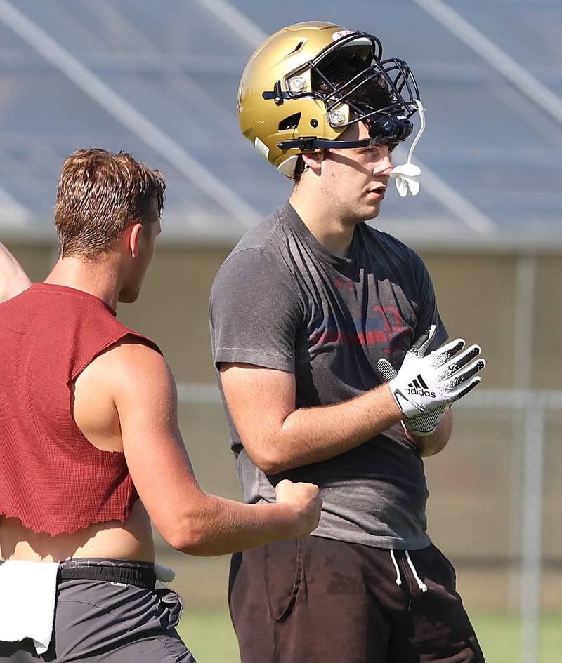 Hiawatha's Cole Brantley (left) and Zach Edwards celebrate a good offensive play Wednesday, Aug.10, 2022, during practice at the school in Kirkland.