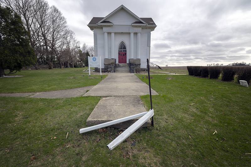 A downspout is seen wrapped around a pole in Holcomb, a village in Ogle County, Friday, April 3, 2026. Thursday evening storms caused a swath of damage across the area.