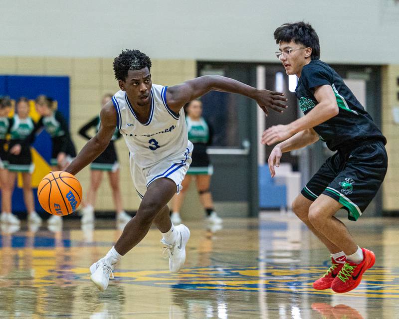 Reggie Chapman (3) of Newark dribbles ball past Leland's defender Isaac Risch (1) during the quarterfinals of the Little Ten Conference Tournament on Monday, Feb. 2, 2026 at Somonauk High School in Somonauk.
