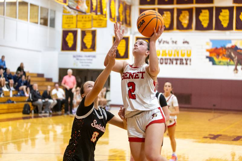 Benet's Sailer Jones goes in for the layup against St. Charles East's Greta Mazurova at the Montini Christmas Tournament on Tuesday, Dec.23,2025 in Lombard.