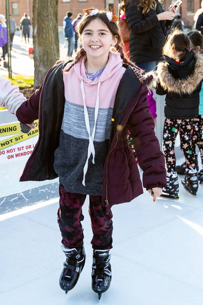 Evelyn Chruscinski, of Lockport, skates on the artificial ice rink during Christmas in the Square in Lockport on Saturday, Nov. 25, 2023.