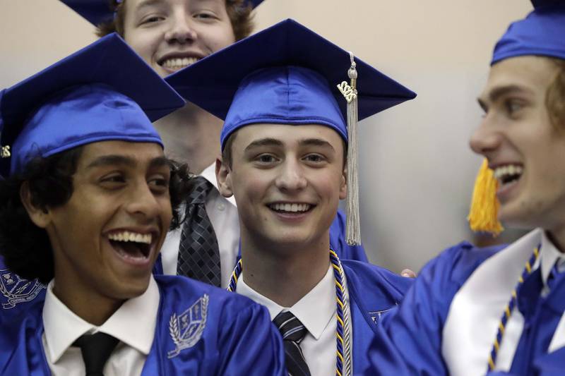 Kevin McCoy, center shares a laugh with some friends before the Burlington Central High School graduation ceremony Thursday May 19, 2022 DeKalb.