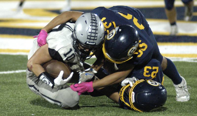 Galesburg player Bradley Eaton is wrapped up by the Sterling defense. The Galesburg Silver Streaks traveled to Sterling to take on the Warriors at Prescott Memorial Field at Roscoe Eades Stadium, September 26, 2025.