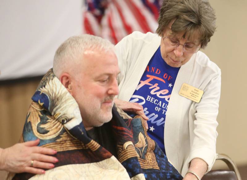 Veteran Tim Puhr, receives his Quilt of Honor from volunteer Barb Donahue during the Quilt of Valor ceremony on Saturday, April 19, 2025 at the Moose Lodge in Princeton.