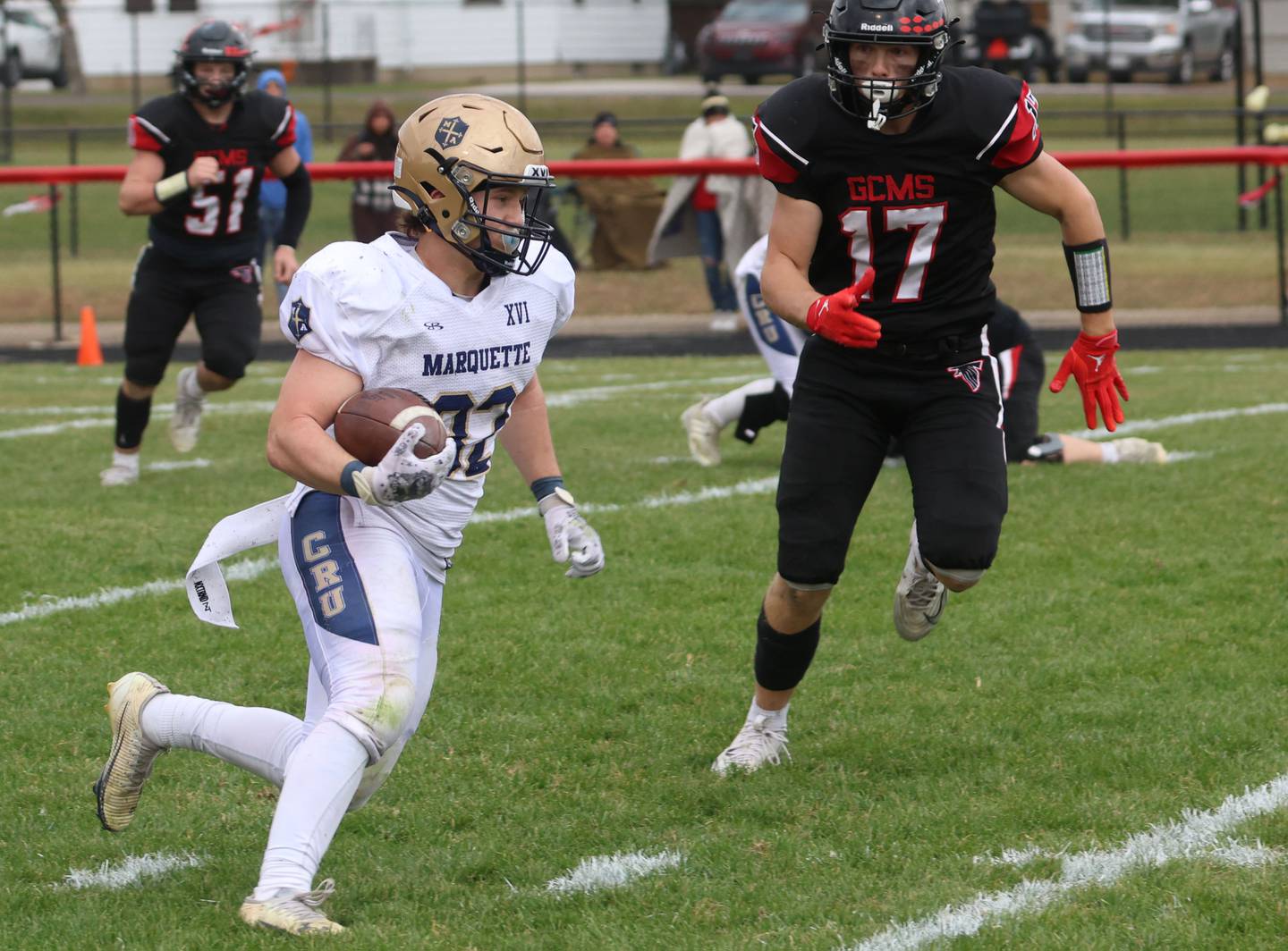 Marquette's Grant Dose takes off with the ball as Gibson City-Melvin-Sibley's Zeb Greer runs toward him during the Class 1A playoff game on Saturday, Nov. 1, 2025 at Gibson City-Melvin-Sibley High School.