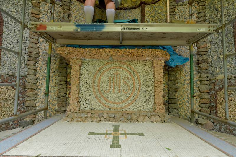 Volunteers work on restoring the Geneva Grotto, that was built by a priest in the 1930s, on Thursday, June 15, 2023.