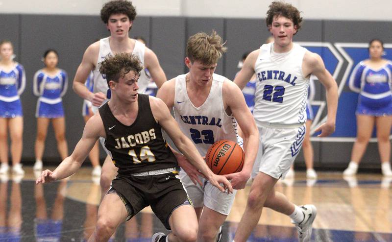 Burlington Central’s Jacob Johnson gets tangled up with Jacobs’ Brett Schlicker in varsity boys basketball at Burlington Tuesday night.