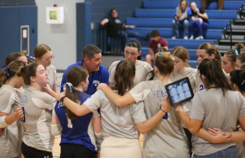 Members of the Princeton volleyball team huddle during a timeout with head coach Andy Puck in the Class 2A Regional Semifinals on Tuesday, Oct. 29, 2024 at Fieldcrest High School.