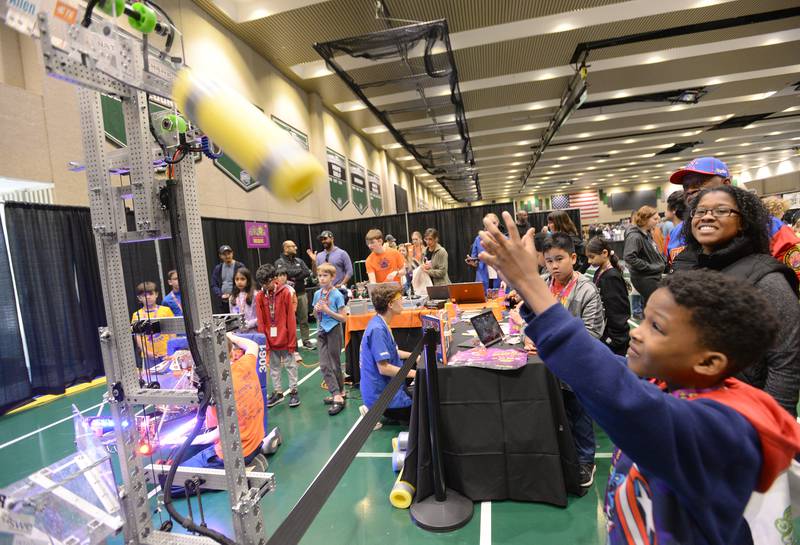 Children including Austin Mess of Addison interact with robots created by local high school students during the STEMCON event on Saturday April 26, 2025 at the College of DuPage in Glen Ellyn.