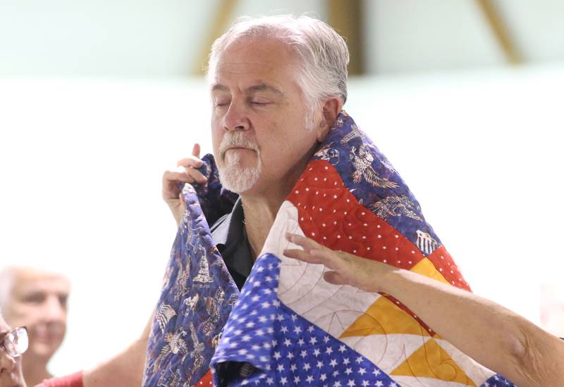 U.S. Marine Corps Veteran Dan Smith, of Princeton, receives his Quilt of Valor during the Tribute to Veterans on Wednesday, Aug. 20, 2025 at the Bureau County Fair in Princeton.