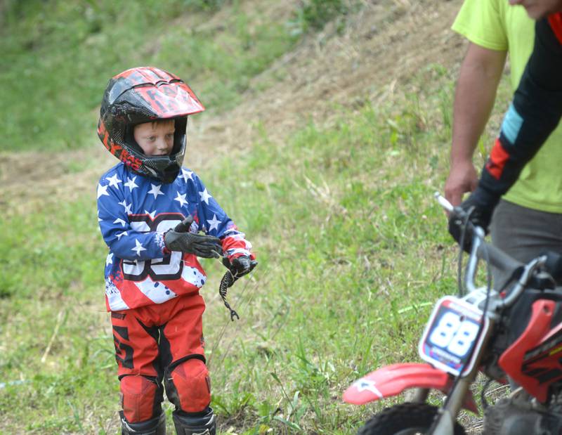 Kaeden Greenham, 6, of Morrison, dusts himself off and checks his bike after making a run in the kids' division at the Rock River Riders Motorcycle Club's Father's Day Hillclimb on Sunday, June 15, 2025.