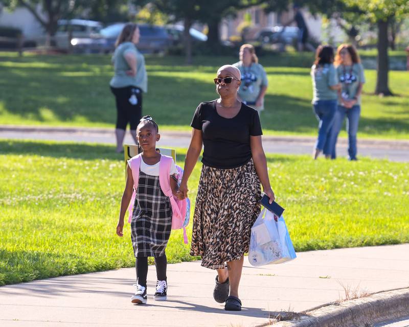 Tonya Biglow, mom, walks with her daughter Alexandria Biglow to Fox Chase Elementary in Oswego for the start of the first day of class held on Wednesday Aug. 16, 2023.