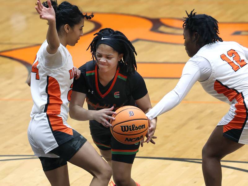 Plainfield East's Gianna Thompson drives betwen DeKalb's Nazeria  Dean (left) and Angela Gary Thursday, Feb. 12, 2026, during their game at DeKalb High School.
