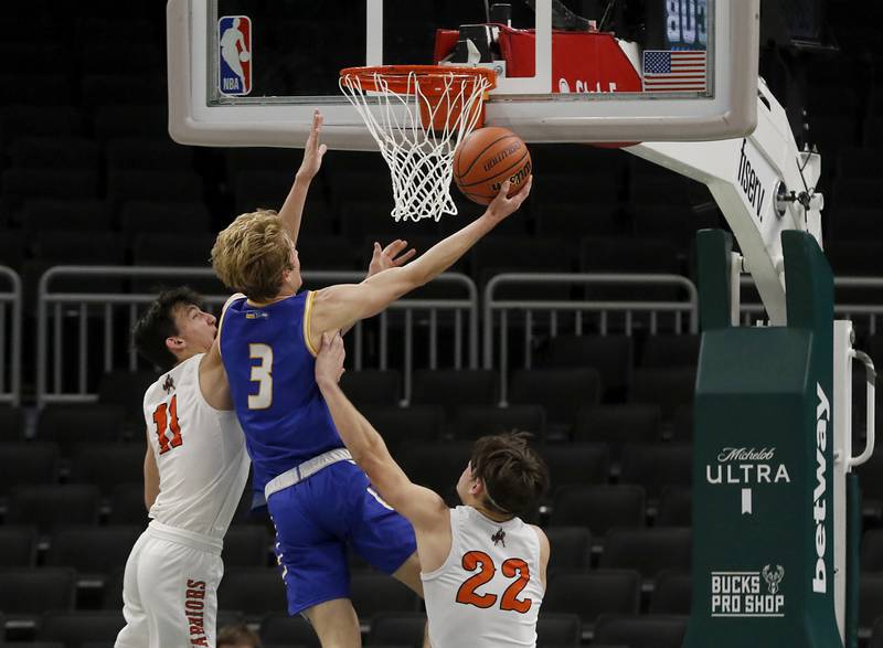 Johnsburg's Dylan Schmidt drives to the basket between McHenry's Hayden Stone, left, and Conner McLean, right. during a non-conference basketball game Sunday, Nov. 27, 2022, between Johnsburg and McHenry at Fiserv Forum in Milwaukee.