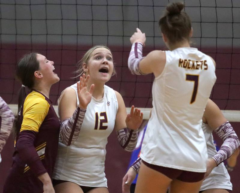 From left, Richmond-Burton’s Delanee Cooley, Zoe Freund and Alex Hopp celebrate a point in IHSA Class 2A Regional Title Game volleyball action on Thursday, Oct. 31, 2024, at  Marengo High School  in Marengo.
