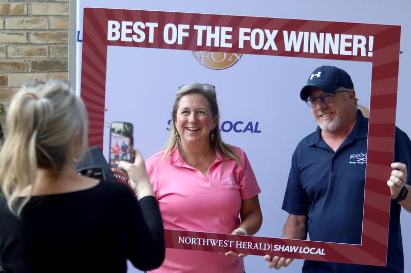 Jennifer Johnson, left, and Andreas Kuhn of Woodstock Heating, Colling, Electrical pose for pictures during the Shaw Local Media Best of the Fox celebration at Lou’s Lounge at the Dole in Crystal Lake on Thursday, Sept. 18, 2025. Their firm was recognized as One of the Best in the HVAC category. Both are managers at the firm.