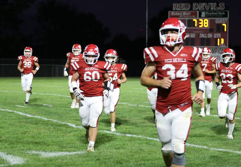 Hall Red Devil players hustle to the sidelines after Kewanee scored a touchdown on Friday, Sept. 27, 2024 at Richard Nesti Stadium.