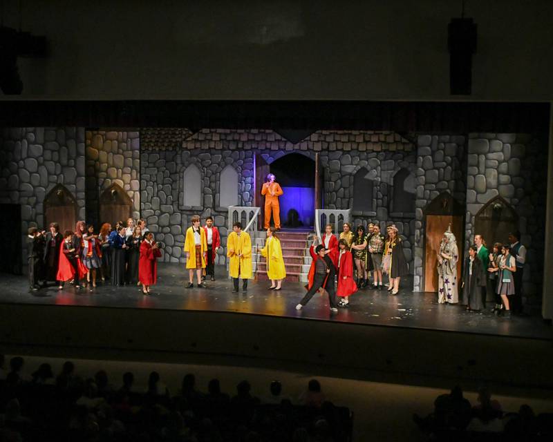 Downers Grove North cast members come together during the production of Puffs  to hear the results of a compatition that was part of the play on Saturday Nov. 23, 2024, held at Downers Grove North’s auditorium.