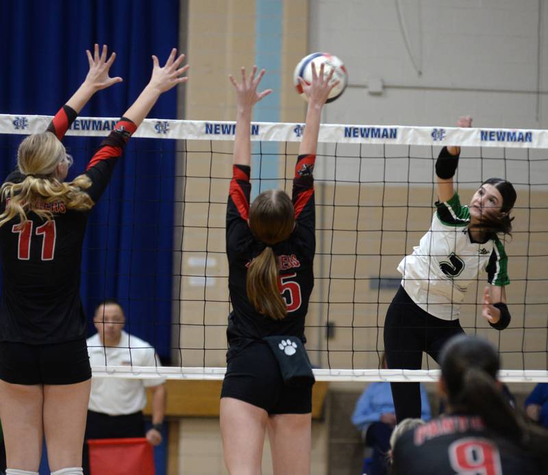 Rock Falls' Kaltrina Lecaj (2) spikes the ball as Erie-Prophetstown's Lauren Abbott (11) and Kaylee Keegan (15) block during the championship of the 2A Sterling Newman Regional on Thursday, Oct. 31, 2024.