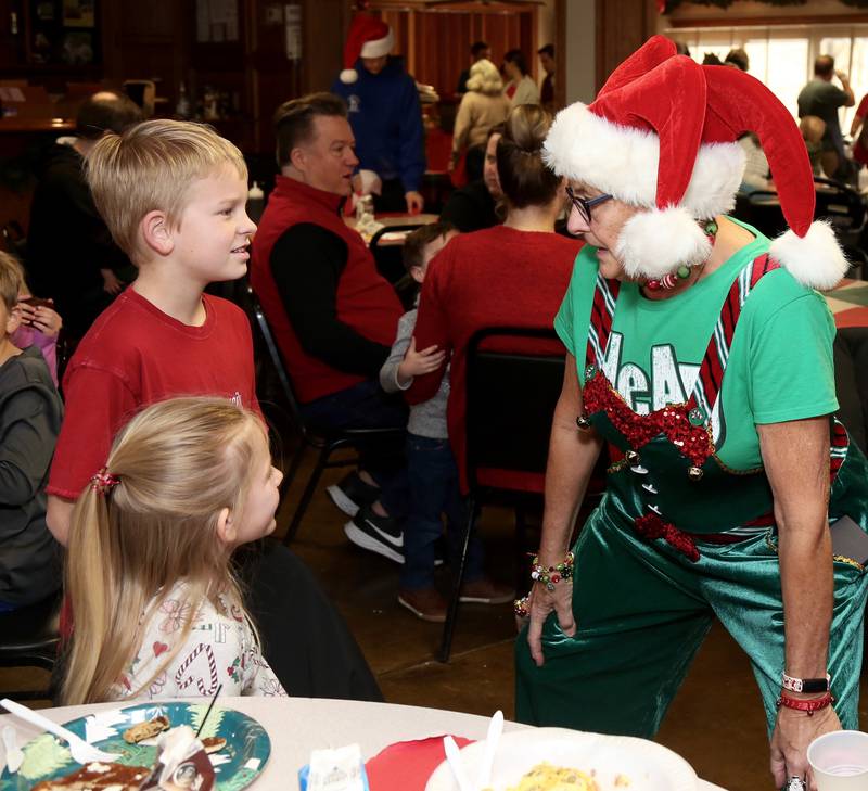 Blake and Savannah Linder of St. Charles talk with one of Santa’s elves (Cheryl Lee) at Breakfast with Santa in Elburn on Sunday, Dec. 4, 2022.
