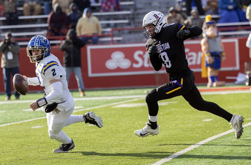 Maroa-Forsyth's Ryne Sheppard scrambles out of the pocket as Chicago Christian's Demo Griggs chases him Friday, Nov. 29, 2024, in the class 2A football state final.