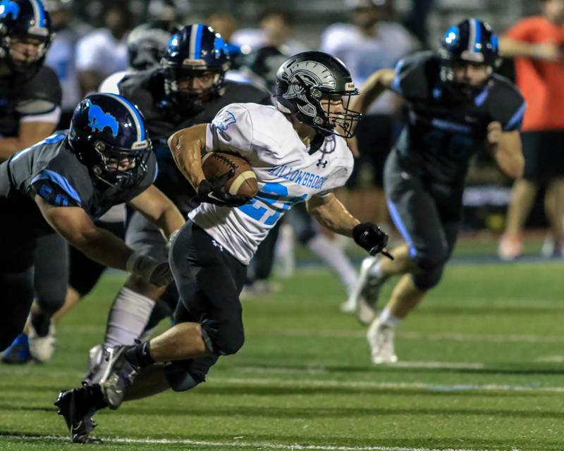 Willowbrook's Joe Hanson (21) is pursued behind the line by 
Downers Grove South's Joe Genna (50) during varsity football game between Willowbrook at Downers Grove South.  Sept 16, 2022