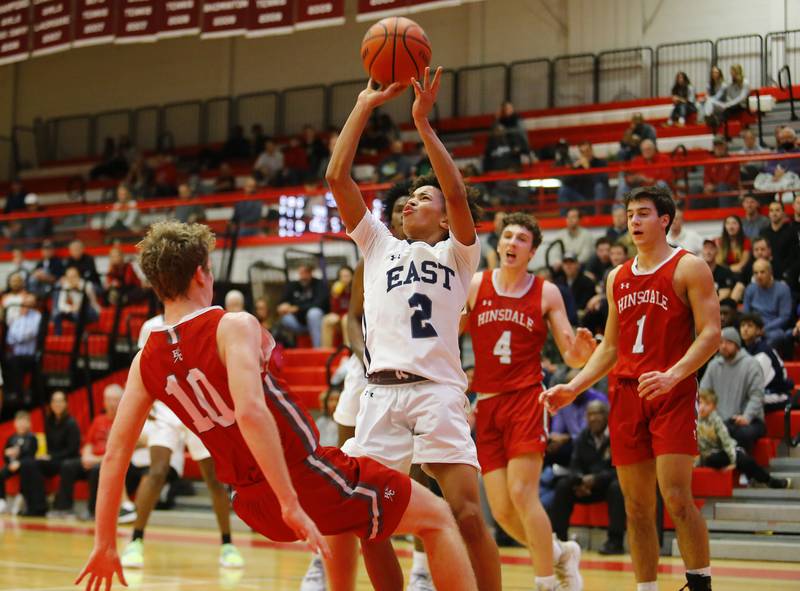 Oswego East's Bryce Wiggins (2) forces a shot during the Hinsdale Central Holiday Classic championship game between Oswego East and Hinsdale Central high schools on Thursday, Dec. 29, 2022 in Hinsdale, IL.