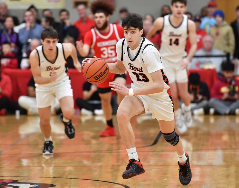 Benet's Niko Abusara (23) races to the basket after stealing the ball in the opening moments of the game during a "When Sides Collide" invitational game against Kenwood on Jan. 21, 2023 at Benet Academy in Lisle.