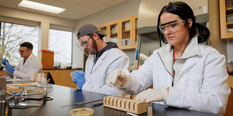Kishwaukee College students using science class laboratory equipment